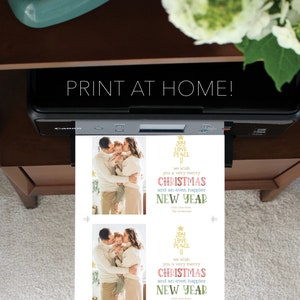 May include: A white sheet of paper emerging from a black Canon printer featuring two identical Christmas card designs. Each card displays a photograph of a family of three and text that reads: JOY LOVE PEACE, we wish you a very merry CHRISTMAS and an even happier NEW YEAR with love from, The Andersons.