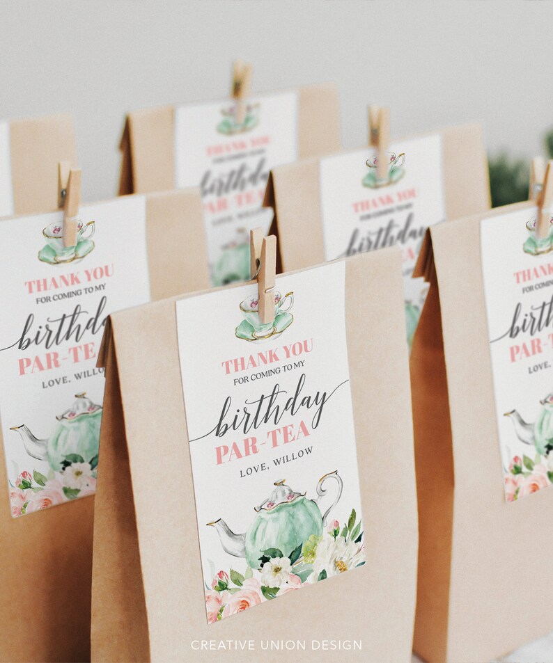 May include: Thank you for coming to my birthday par-tea.  A brown paper bag with a pink and green tea party favor tag featuring a teapot, flowers, and the text "Thank you for coming to my birthday par-tea. Love, Willow".
