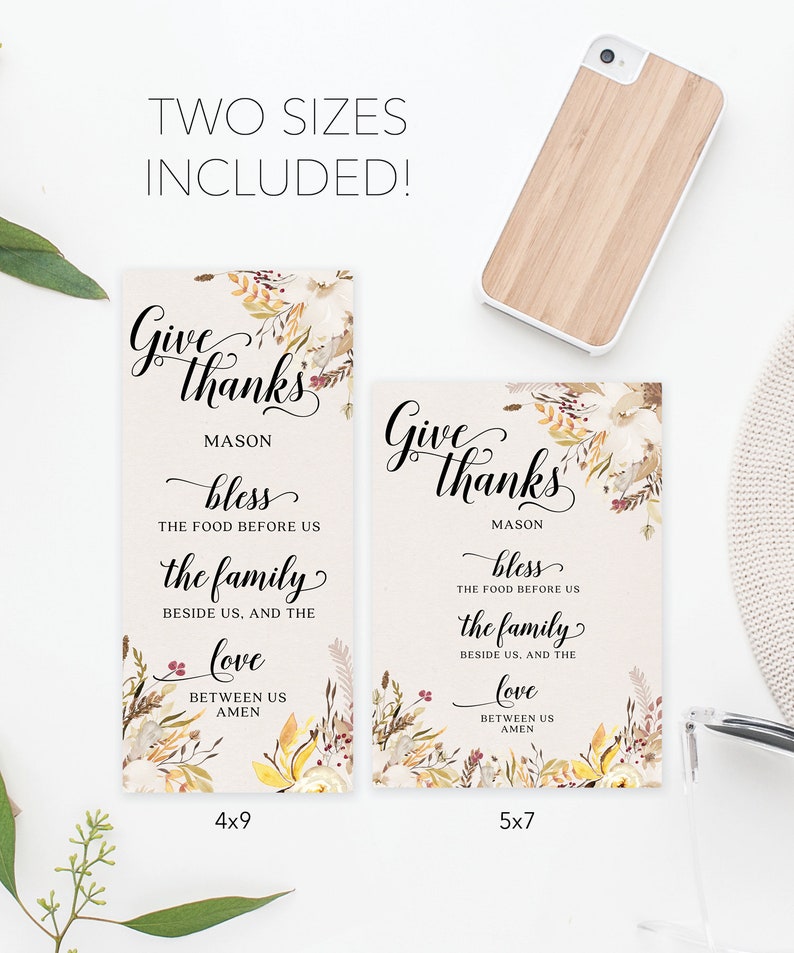 May include: Two rectangular signs with floral accents and the words "Give thanks" in elegant script. The signs include the text "bless the food before us, the family beside us, and the love between us, amen." One sign is 4x9 inches, the other is 5x7 inches.