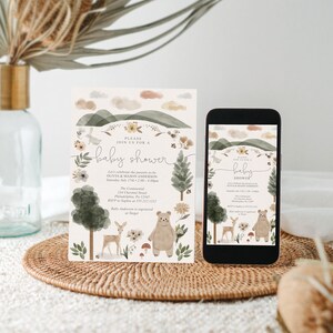 May include: A baby shower invitation with a woodland theme. The invitation features a watercolor illustration of a forest with a bear, deer, and a rabbit. The text on the invitation reads "Please join us for a baby shower" and includes the names Olivia & Mason Anderson, the date and time of the shower, the location, and the RSVP information. The invitation also includes the text "Baby Anderson is registered at Target."