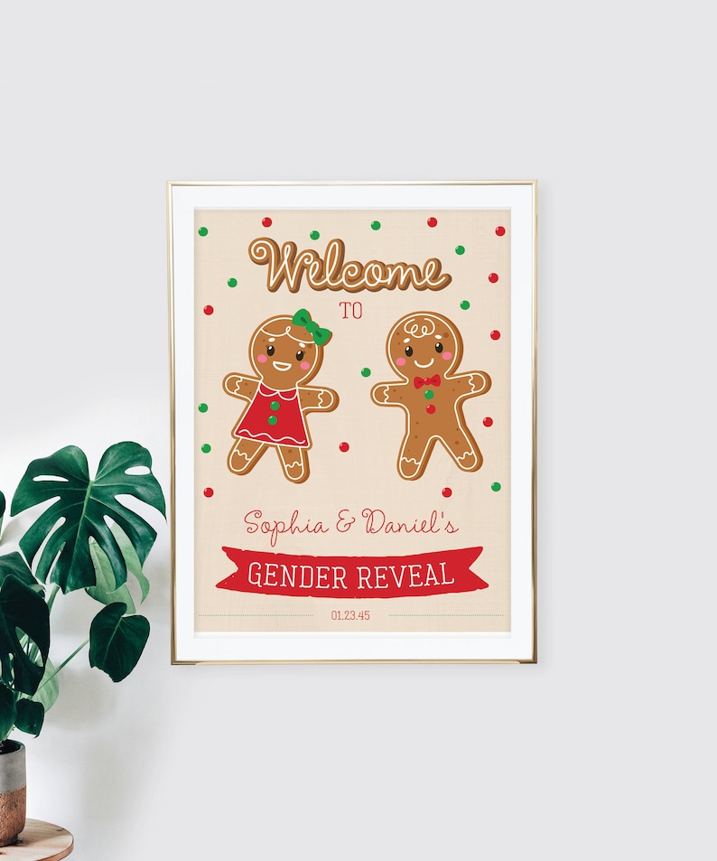 May include: A framed gender reveal print featuring gingerbread people. The print reads "Welcome to Sophia & Daniel's Gender Reveal" with a date below. The gingerbread figures are decorated with red, green, and brown accents.