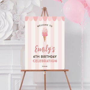 May include: A pink and white striped welcome sign on a wooden easel. The sign reads "Welcome to Emily's 4th Birthday Celebration" with an ice cream cone graphic. Pink balloons are in the background.