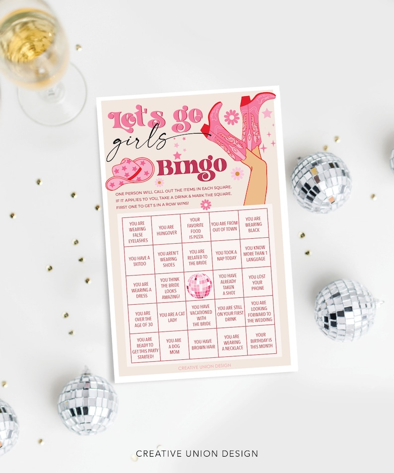 May include: A pink and white bingo card with the text "Let's go girls Bingo" at the top. The card has a pink and white disco ball in the center and is surrounded by squares with various phrases related to a bachelorette party.