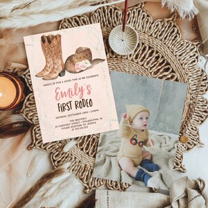 May include: A pink and white invitation with a watercolor illustration of cowboy boots and a hat. The text reads "Saddle up for a good time as we celebrate Emily's First Rodeo". The invitation includes the date, time, location, and contact information.