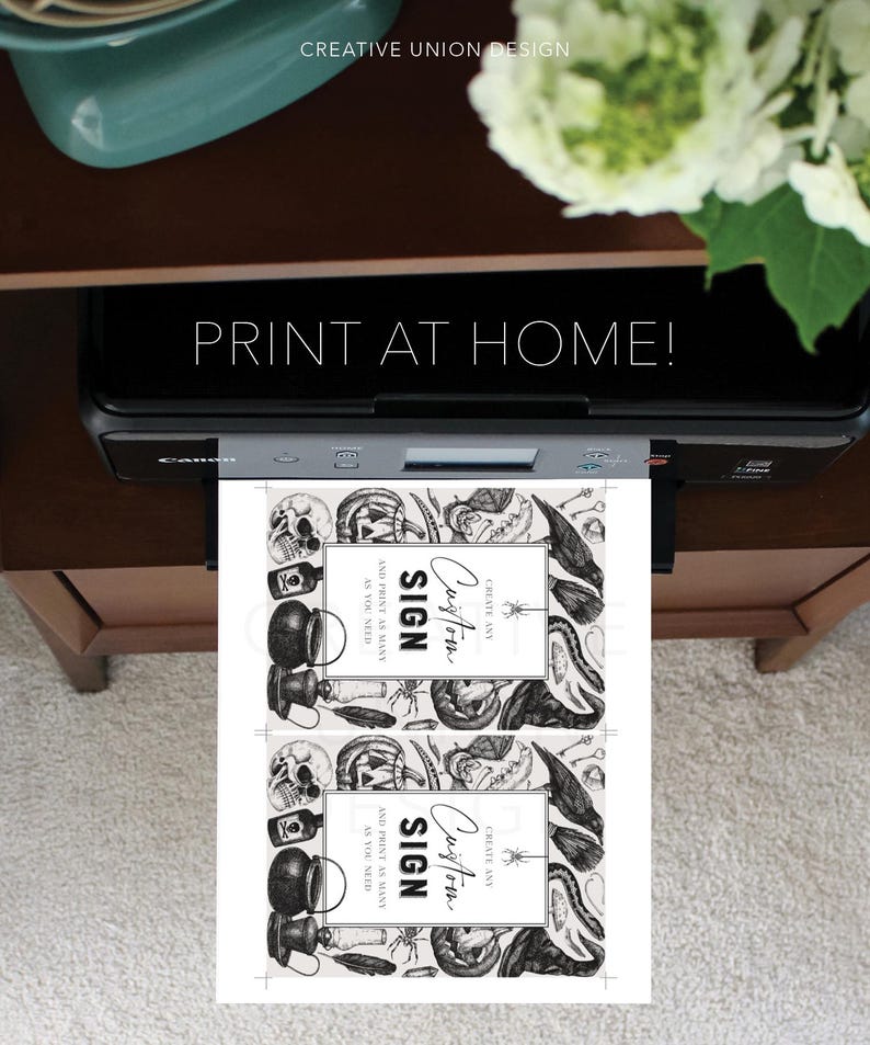 May include: A printer is shown printing two Halloween-themed signs. The signs feature a border of skulls, spiders, and other spooky elements. The text on the signs reads "Custom Sign" and "Print as many as you need". The image also includes the text "Print at Home!"