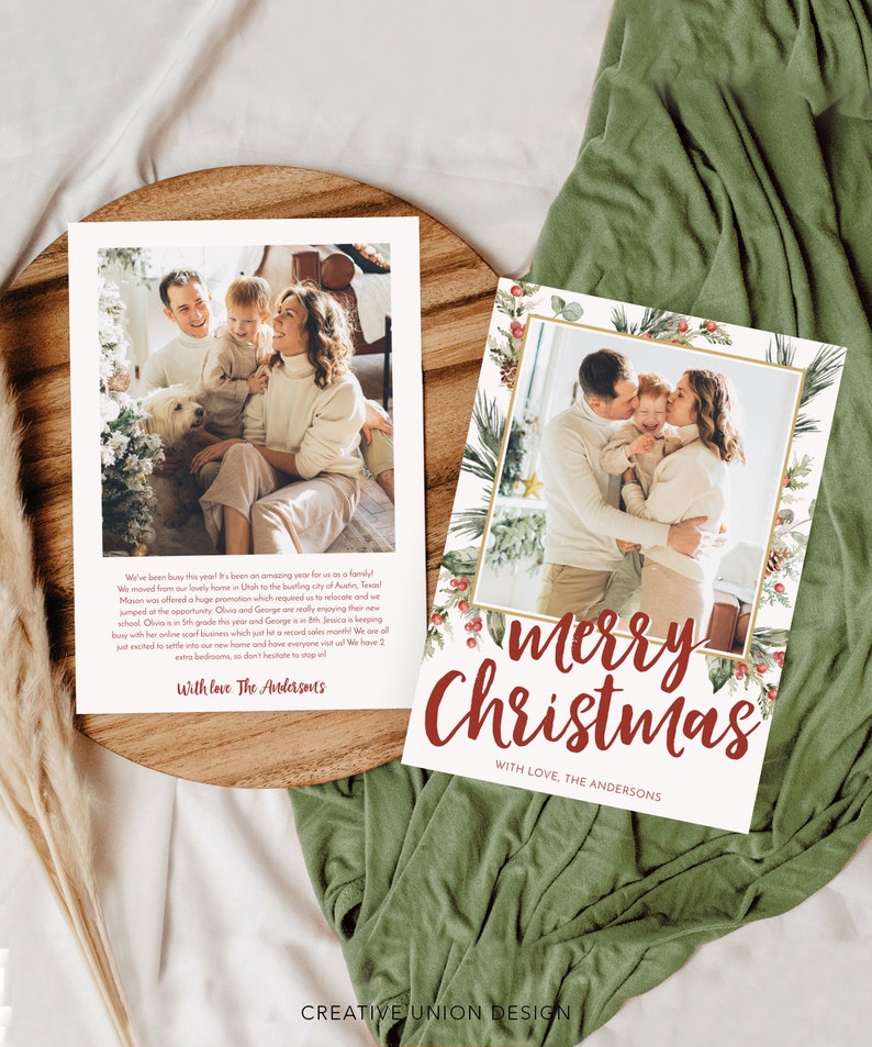 May include: Two Christmas cards with family photos. One card says "Merry Christmas" in red script with a decorative border. The other card has a family photo and text. Both cards are on a wooden tray.