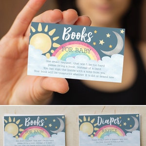 May include: Two blue and white cards with a rainbow, sun, and moon design. The text on the cards reads "Books for Baby" and "Diaper Raffle".