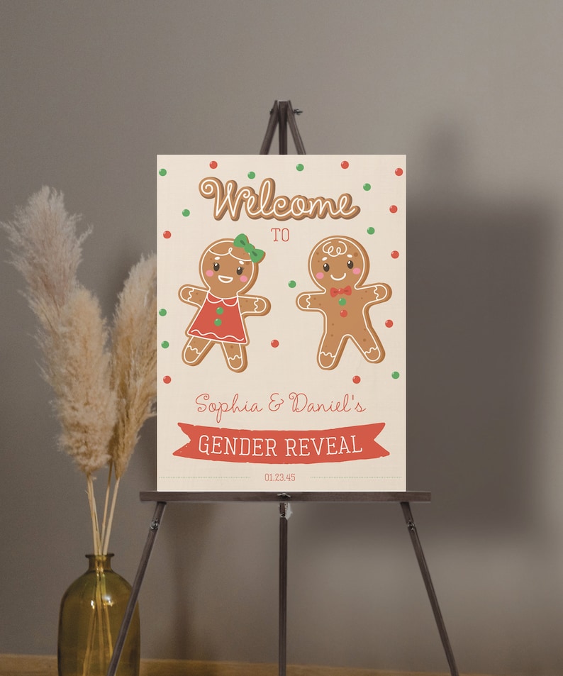 May include: A gender reveal sign on an easel. The sign features two gingerbread people, one in a red dress and the other with a bow tie. The text reads "Welcome to Sophia & Daniel's Gender Reveal" with the date 01.23.45.