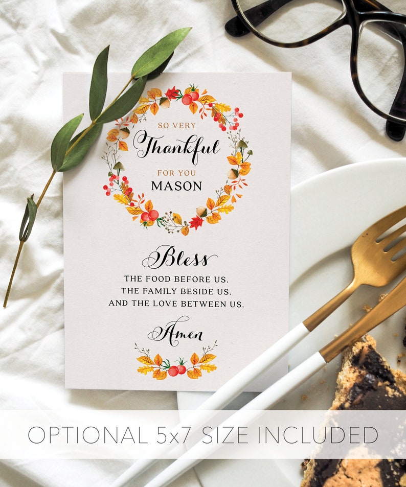 May include: A Thanksgiving place card with a watercolor wreath of fall leaves and berries. The card says "So very thankful for you Mason" and "Bless the food before us, the family beside us, and the love between us. Amen".