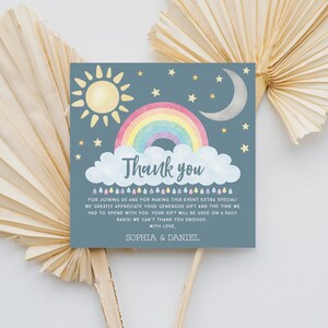 May include: A blue thank you card with a rainbow, sun, moon, and stars. The text reads "Thank you" and "For joining us and for making this event extra special! We greatly appreciate your generous gift and the time we had to spend with you. Your gift will be used on a daily basis! We can't thank you enough. With love, Sophia & Daniel."