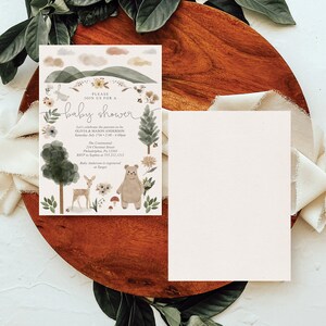 May include: A baby shower invitation with a woodland theme. The invitation features a watercolor illustration of a bear, a deer, and a forest scene. The text on the invitation reads "Please join us for a baby shower" and includes the date, time, and location of the event. RSVP information is also included.