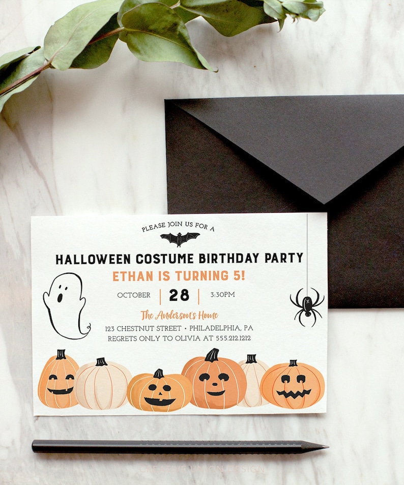 以下が含まれることがあります： ハロウィーンのコスチューム誕生日パーティーの招待状。お化け、クモ、カボチャが描かれています。招待状には「イーサンは5歳！」と書かれており、日付、時間、住所も記載されています。黒い封筒と鉛筆も画像にあります。