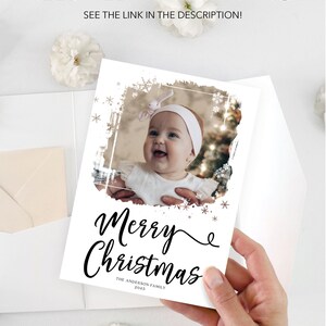 May include: A white Christmas card with a photo of a baby, the words "Merry Christmas" in black script, and the family name. The card is held by a hand. Text at the top reads "NEED HELP WITH PRINTING? SEE THE LINK IN THE DESCRIPTION!"
