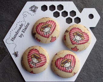 May include: Four handmade fabric buttons featuring a heart design and a girl's face in the centre. Each button has the word "LOVE" printed on it. The buttons are displayed on a white card with the text "Handmade by Elaine".