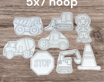 May include: A selection of white felt construction-themed cutouts, including a dumper truck, bulldozer, cement mixer, steamroller, stop sign, excavator, traffic cone, and a construction worker. The text "5x7 hoop" is at the top.