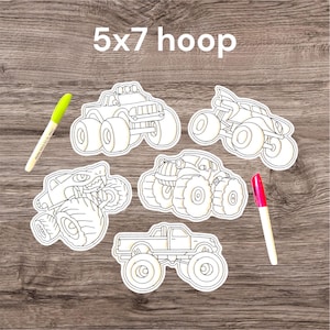 May include: A set of four white monster truck outlines for coloring, each featuring distinct vehicle designs with large tires. The set includes a lime green dry erase marker and a pink dry erase marker. The text 5x7 hoop is visible.