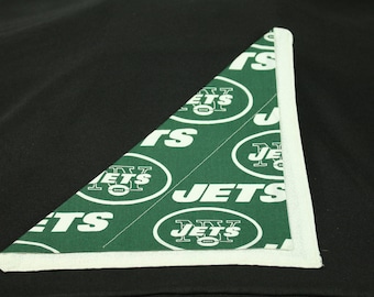 May include: A white and green triangular fabric with the words "New York Jets" repeated on it. The fabric has a white border.