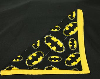 May include: A black bandana with a yellow border and a repeating pattern of yellow Batman logos.