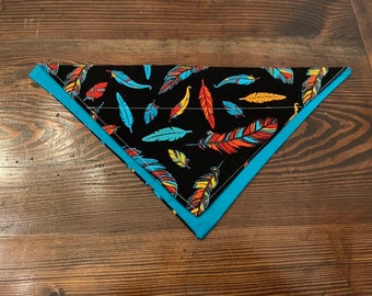May include: A black bandana with a blue trim and a pattern of colorful feathers.