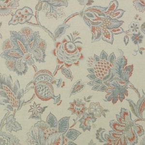 May include: Floral fabric with a cream background and a repeating pattern of stylized flowers and foliage. The flowers are in shades of blue, coral, and gray, with intricate details. The fabric has a vintage or antique aesthetic.