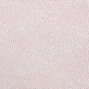 May include: Close-up of a fabric featuring a repeating pattern of small, irregular, light pink dots on a white background. The dots are densely packed, creating a textured appearance. The overall aesthetic is soft and delicate.