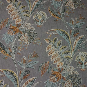 May include: A gray fabric with a floral pattern in shades of blue, orange, and brown. The pattern features stylized leaves and flowers.