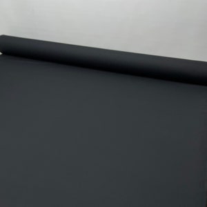 May include: A black roll of fabric, likely for photography backdrops or other creative projects.