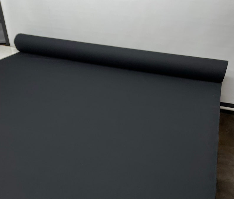 May include: A black roll of fabric, likely for photography backdrops or other creative projects.