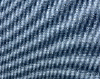 May include: Close-up of a blue fabric with a textured woven pattern.