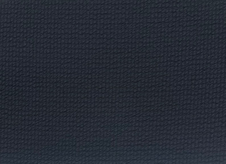 May include: A dark blue textured fabric with a subtle diagonal pattern.