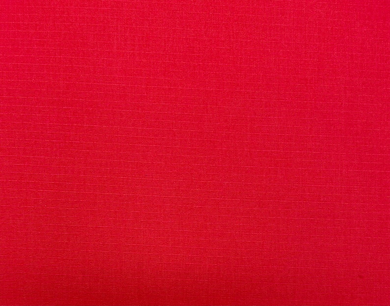 May include: A solid red fabric with a subtle textured pattern.
