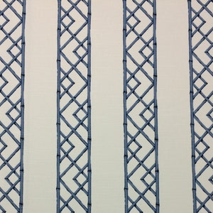 May include: A white fabric with a repeating pattern of blue vertical stripes. Each stripe features a geometric design resembling a lattice or trellis.