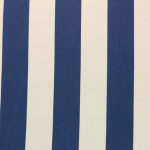 May include: A white and blue striped fabric with a subtle texture. The fabric has vertical stripes, alternating between white and a deep blue color.