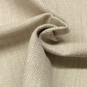 May include: Beige fabric with a woven diamond pattern. The fabric is folded and textured.