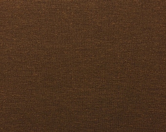 May include: A close-up of a brown fabric with a textured weave. The fabric has a subtle sheen and a slightly rough feel.