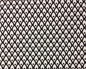 May include: A white and black fabric with a repeating pattern of stylized leaves. The leaves are white on a black background.
