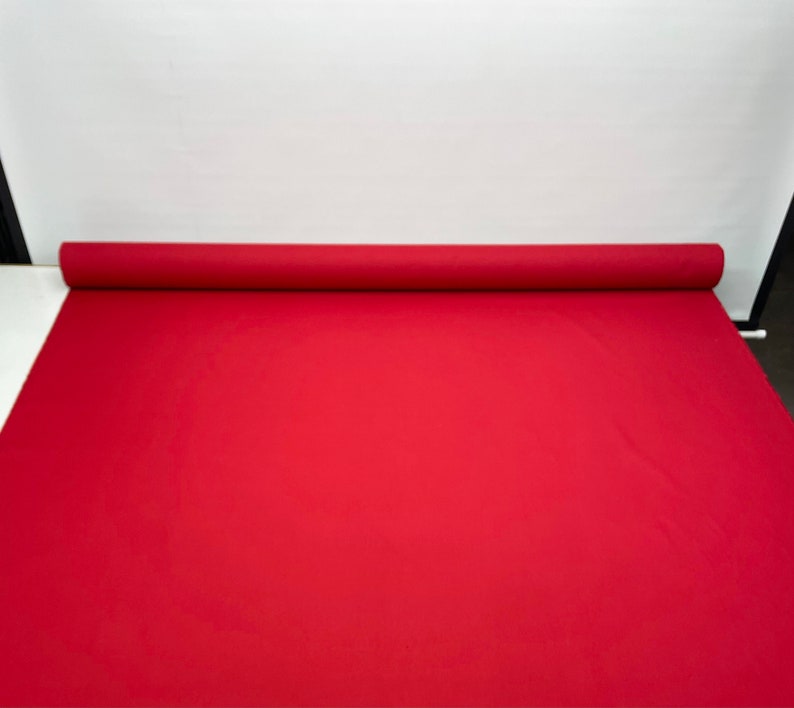 May include: A roll of red fabric, likely for crafts or upholstery.