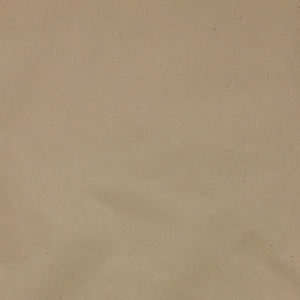 May include: A plain, off-white canvas fabric with a subtle texture. The fabric has a slightly rough, natural feel.