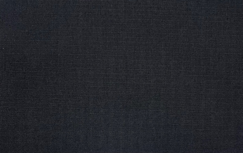May include: A dark blue fabric with a subtle, textured weave. The fabric has a smooth, even surface and a slightly shiny finish.
