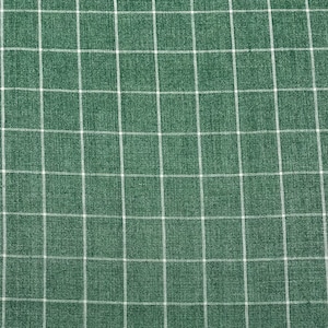 Pode incluir: Tecido verde com um padrão xadrez branco. O tecido tem uma superfície texturizada.