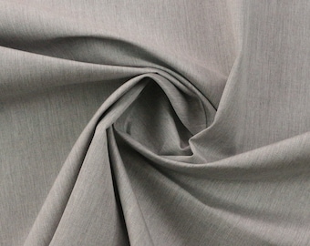 May include: A close-up of a gray fabric with a subtle textured pattern. The fabric is folded and draped, showcasing its soft and smooth texture.