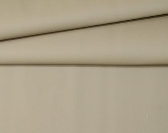 May include: Close-up of a beige fabric with a smooth texture. The fabric is folded in half, creating a soft, gentle curve.