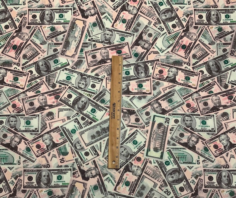 Pode incluir: Um close-up de um tecido com um padr&atilde;o de notas de d&oacute;lar americano. O tecido &eacute; branco com uma variedade de denomina&ccedil;&otilde;es de notas, incluindo $1, $5, $10, $20 e $50.