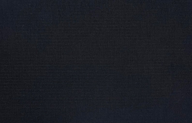 May include: A dark blue fabric with a subtle, textured, woven pattern.