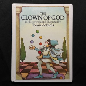 May include: The Clown of God, an old story told and illustrated by Tomie dePaola, features a colorful illustration of a clown juggling balls in a courtyard.