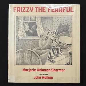 May include: A children's book cover featuring a black and white illustration of a cat in bed wearing glasses and a robe. The title "Frizzy the Fearful" is at the top, with the author and illustrator's names below.