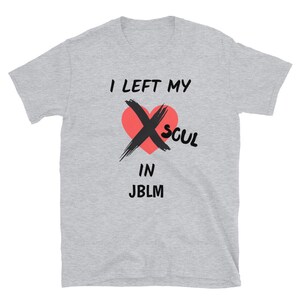 May include: Gray t-shirt with the text "I left my soul in JBLM" printed on it. A red heart with a black X over it is above the text.