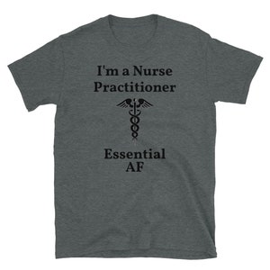 May include: Dark heather grey t-shirt with the text "I'm a Nurse Practitioner" and a caduceus symbol. The text "Essential AF" is below the symbol.