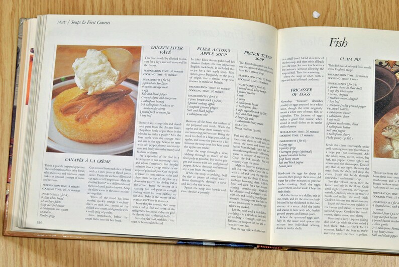 May include: Open cookbook with a recipe for Clam Pie, a traditional New England dish. The page features a close-up of the recipe with the ingredients listed, including clams, butter, flour, and milk.