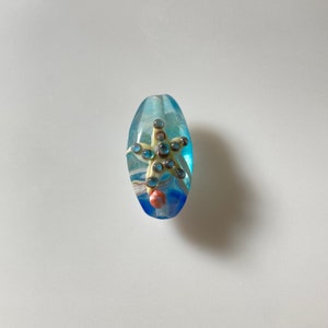 One Oval Lampwork glass 25mmx15mmx10mm blue orange starfish cream starfish